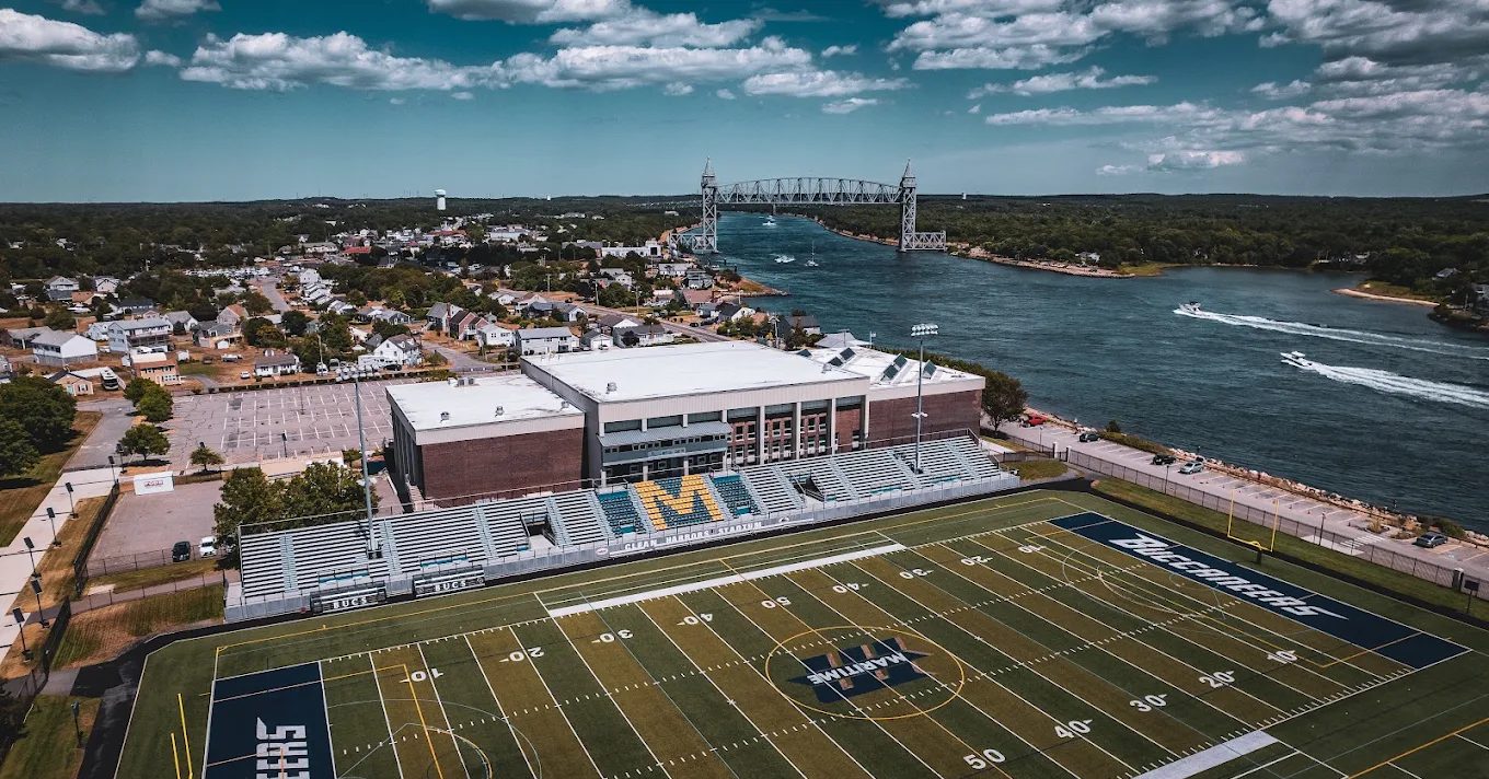 Aerial view of Clean Harbors Stadium at Massachusetts Maritime Academy with the Cape Cod Canal and railroad bridge behind it